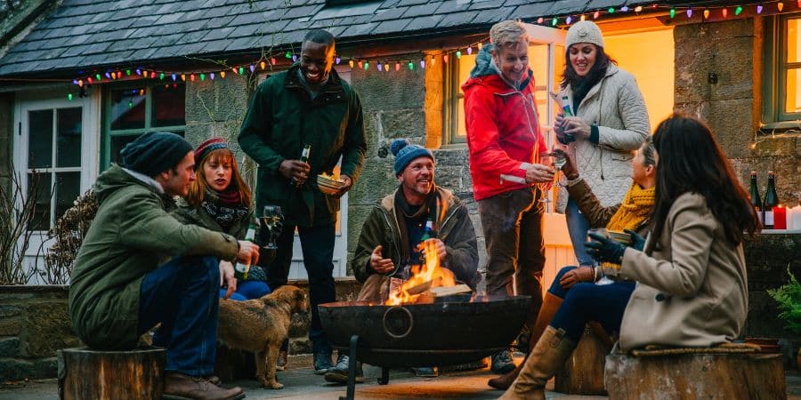 Group of Friends Sitting Around a Fire Pit