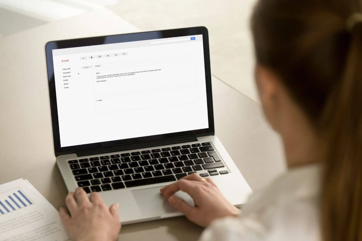 Woman sitting at her laptop composing an email.