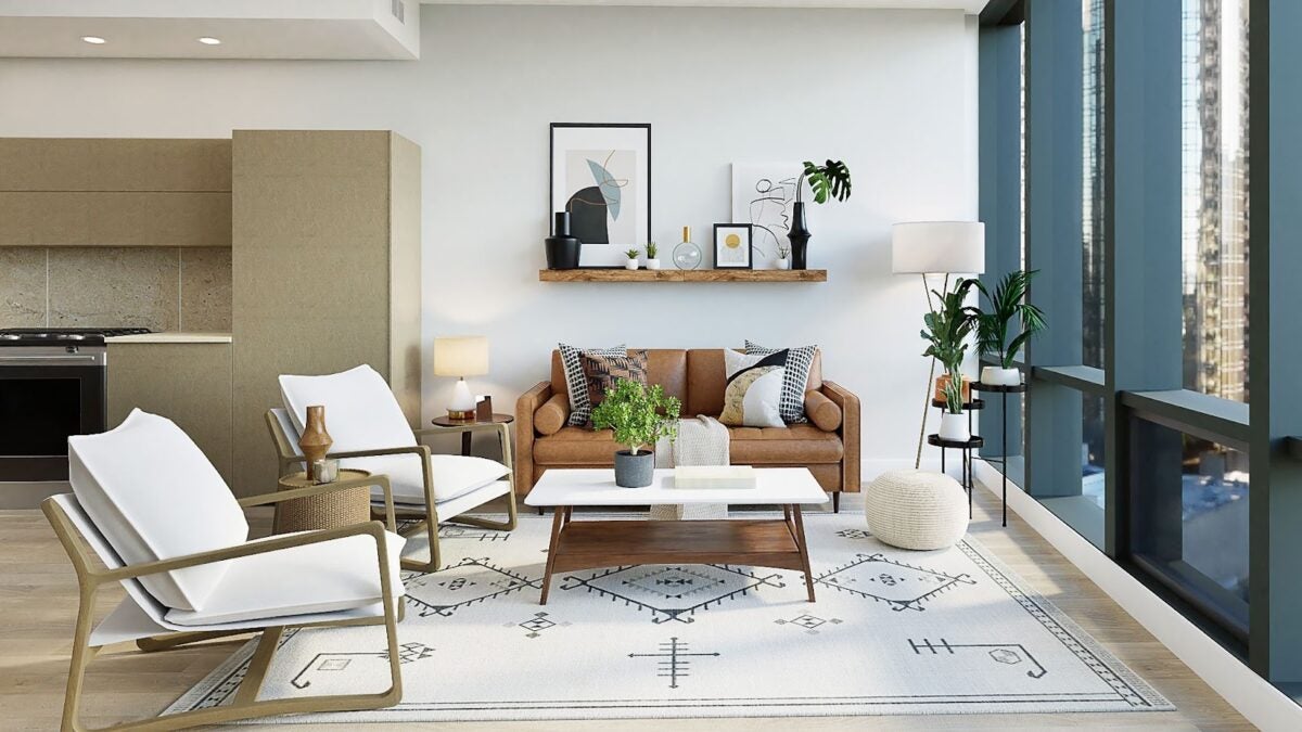 Staged sitting area facing windows overlooking the city with white, beige, and tan colors.