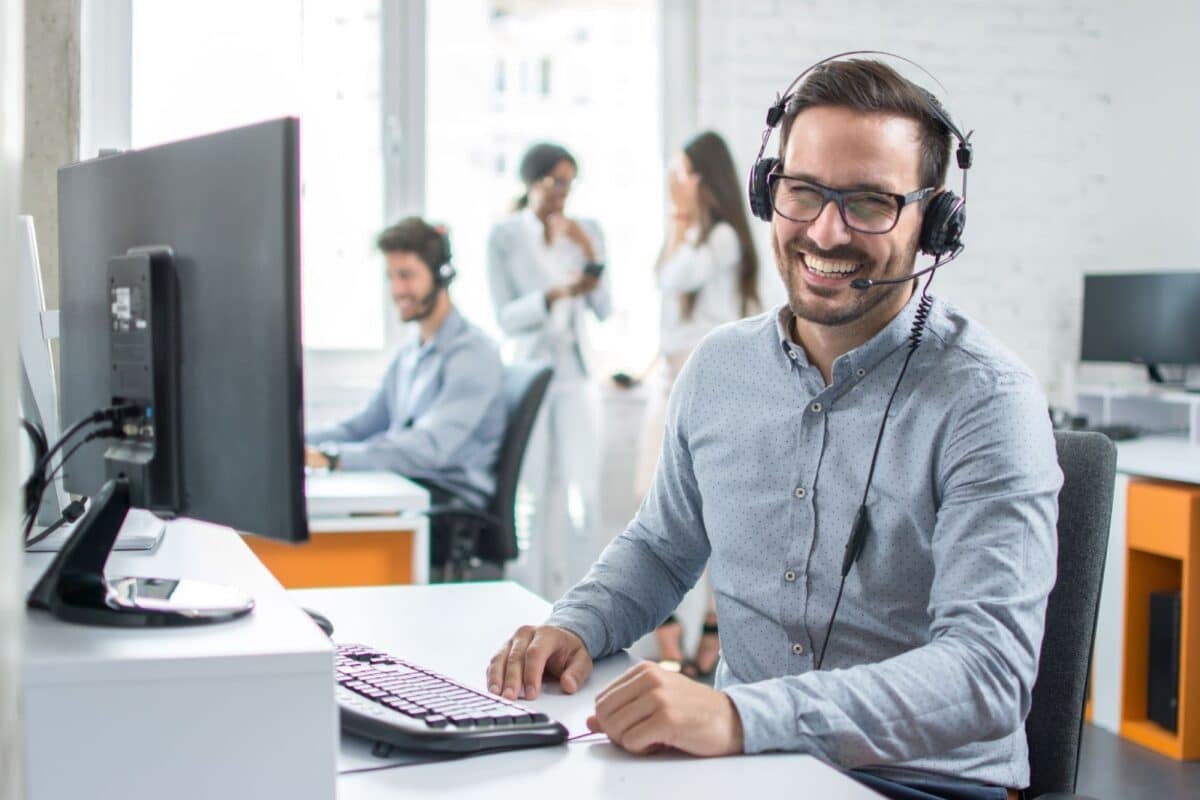 Happy young male assistant working in office.