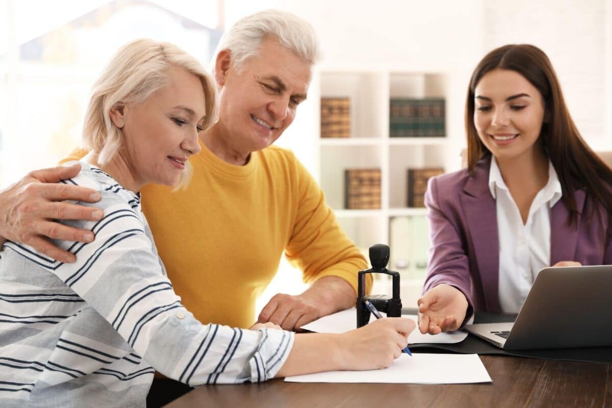 Female notary working with mature couple in office.