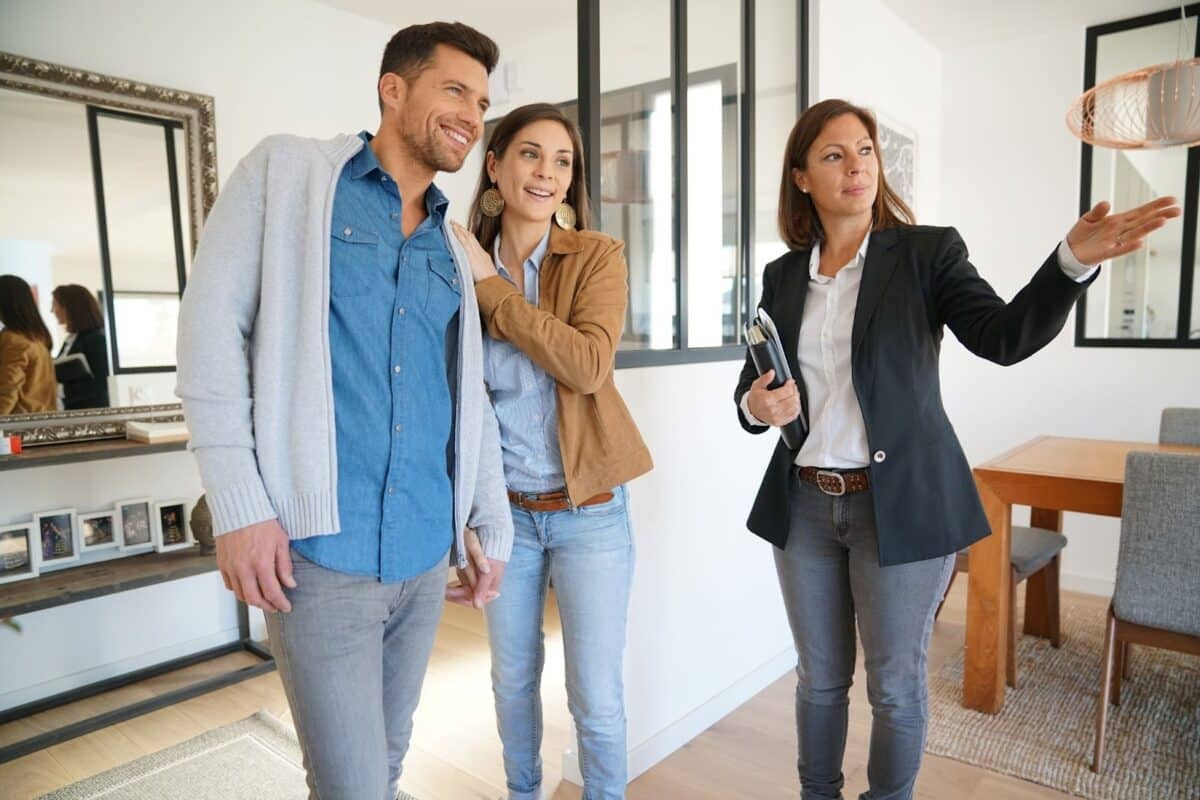 A buyer's agent inside a house with clients on a property tour.