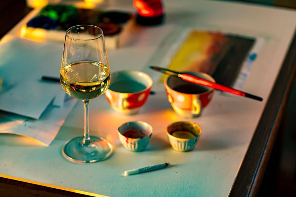 Couple sitting outdoors with a glass of wine and food tray