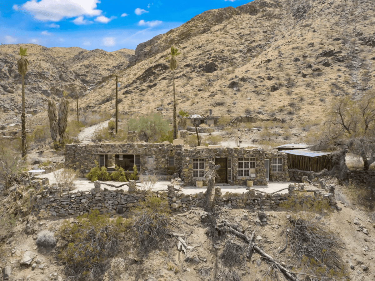 A house made of rocks in the middle of a desert