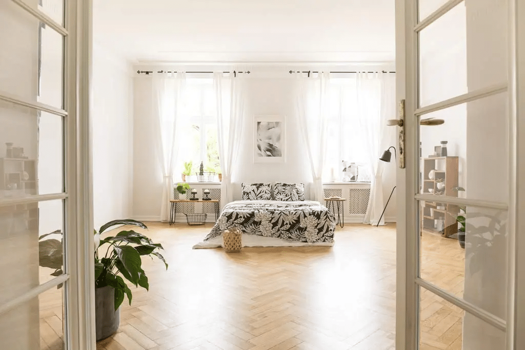 Bedroom with natural sunlight coming through the windows.