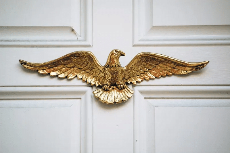 A gold eagle plaque on a home's front door