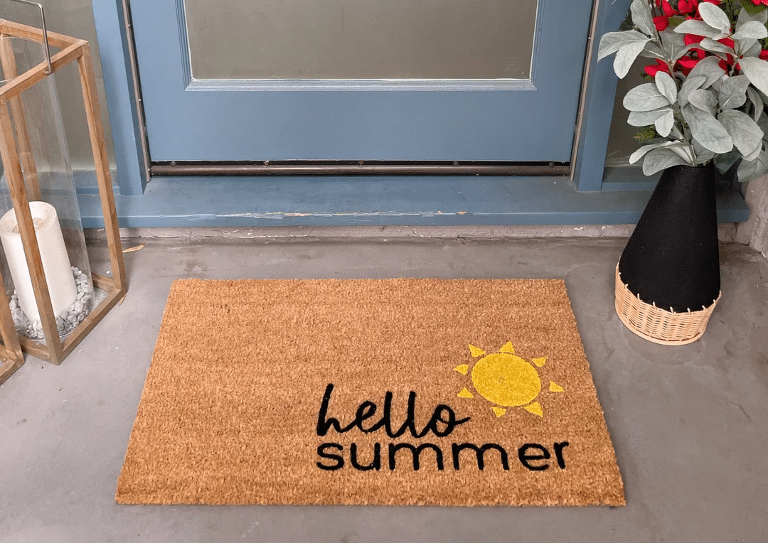 A welcome doormat with "hello summer" written on it