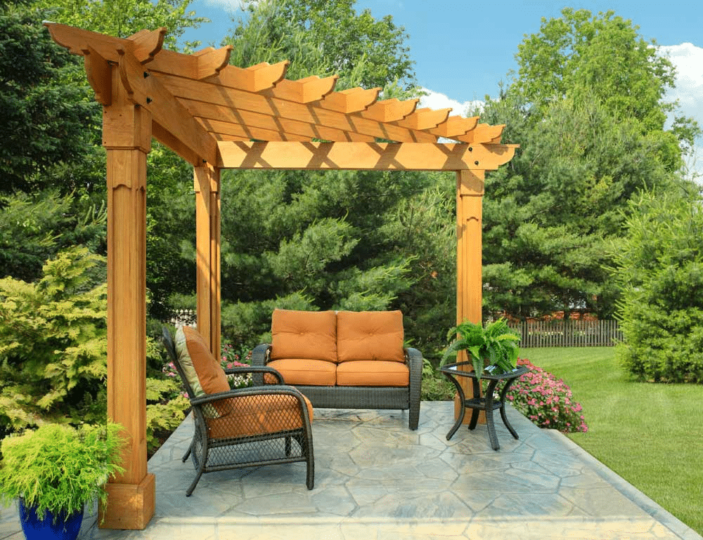 Two outdoor chairs under a pergola on a yard