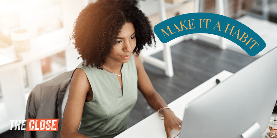 Real estate agent in front of desktop computer