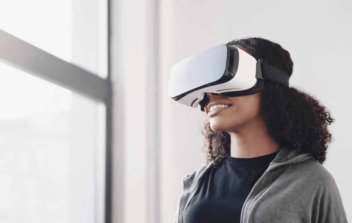 Young woman using VR headset in her home.